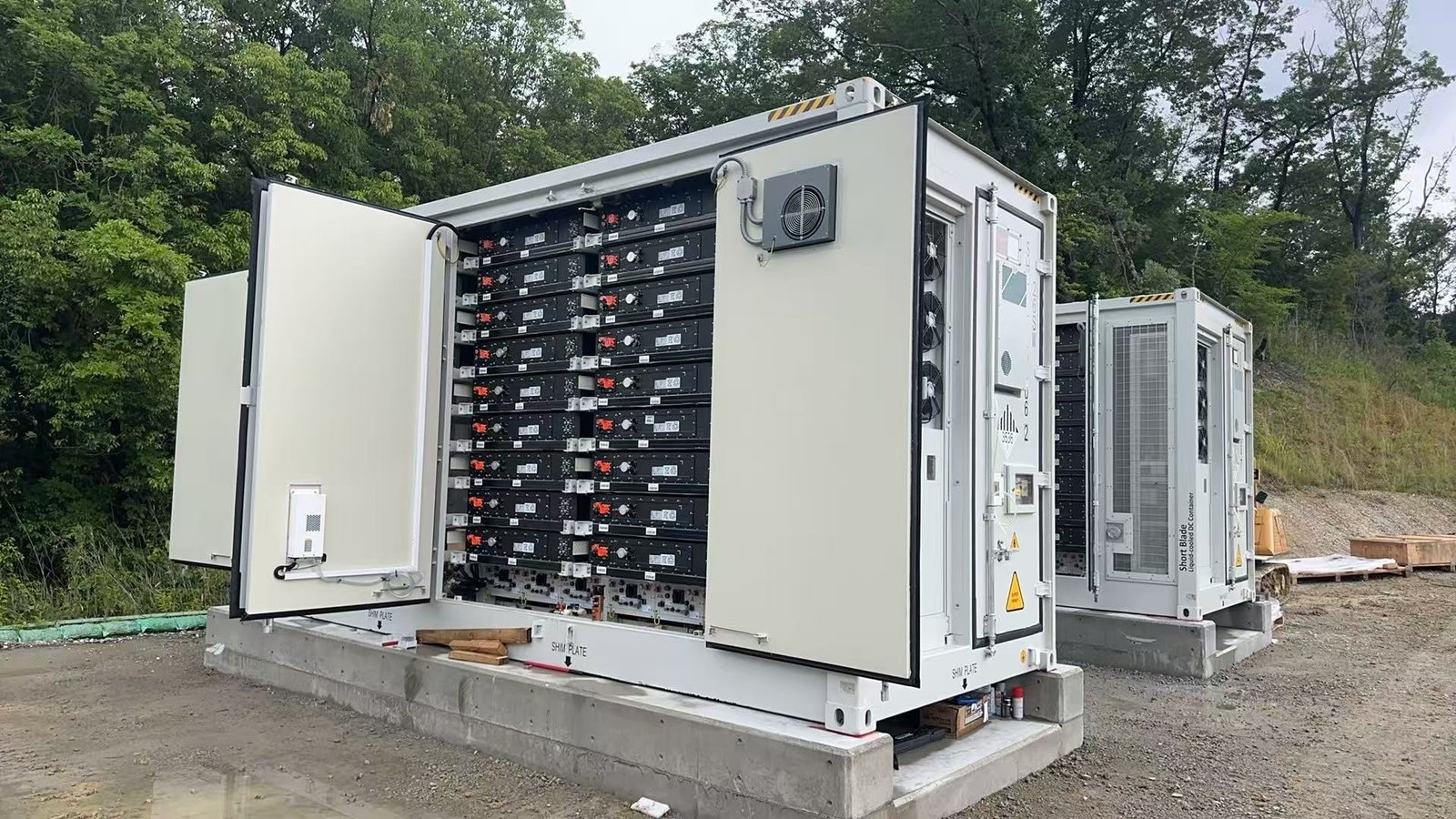 Outdoor battery energy storage cabinets with doors open